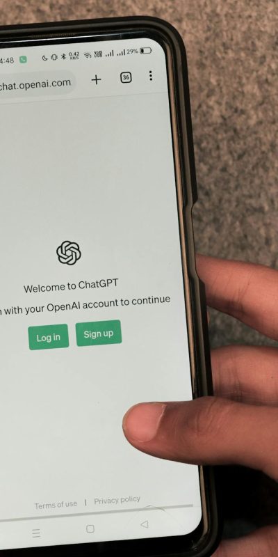 Webpage of ChatGPT, a prototype AI chatbot, is seen on the website of OpenAI, on a smartphone. Examples, capabilities, and limitations are shown.